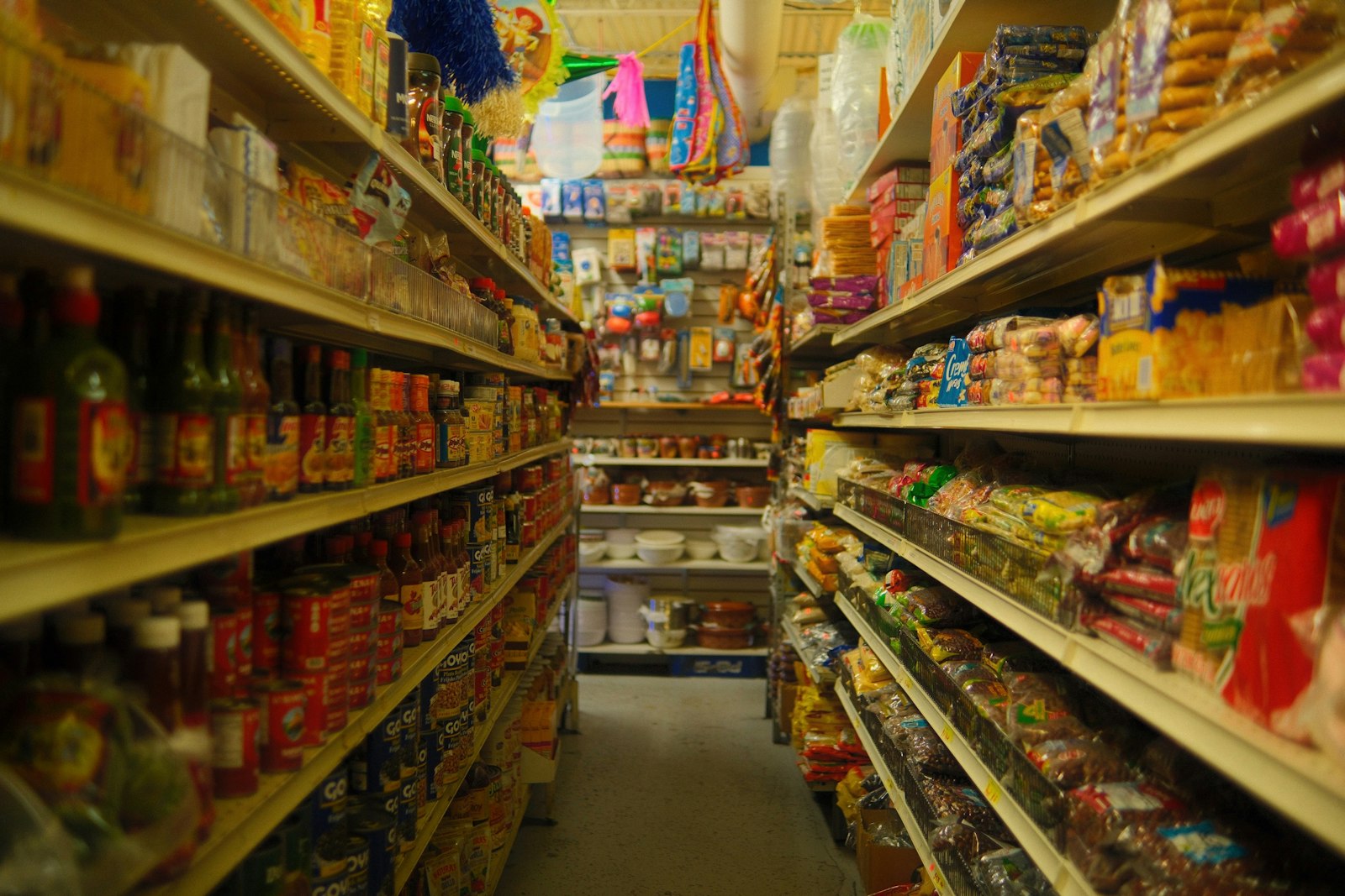 A grocery store aisle lined with stocked shelves