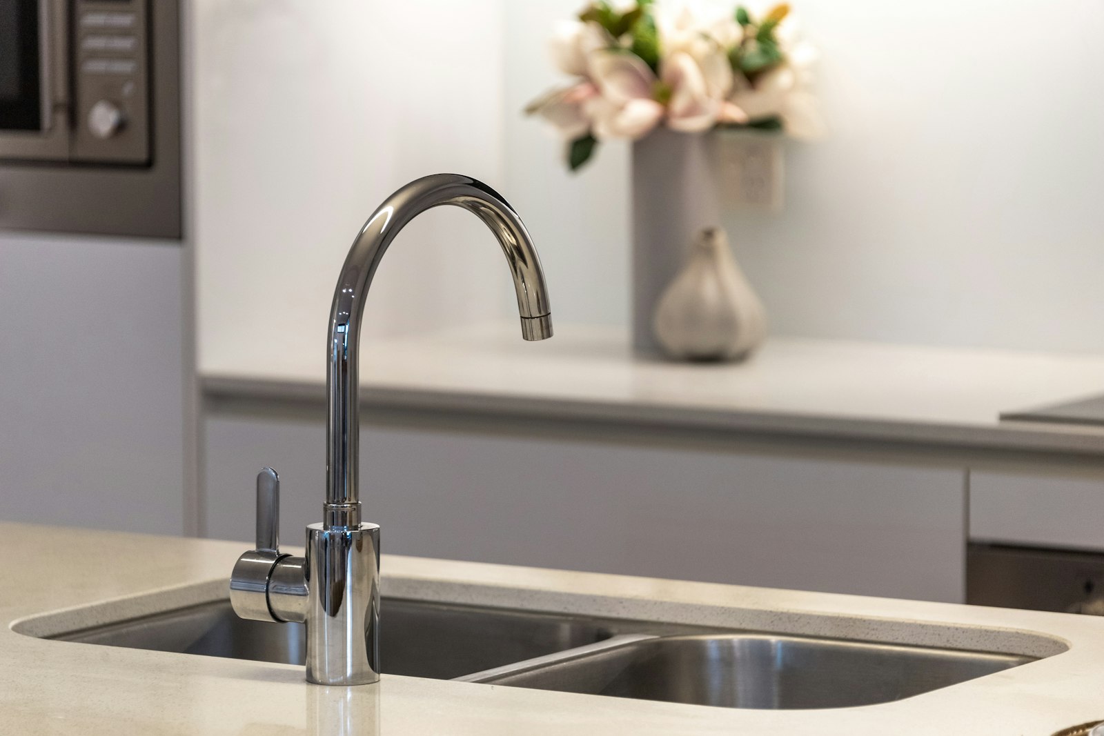 A stainless steel kitchen faucet turned off